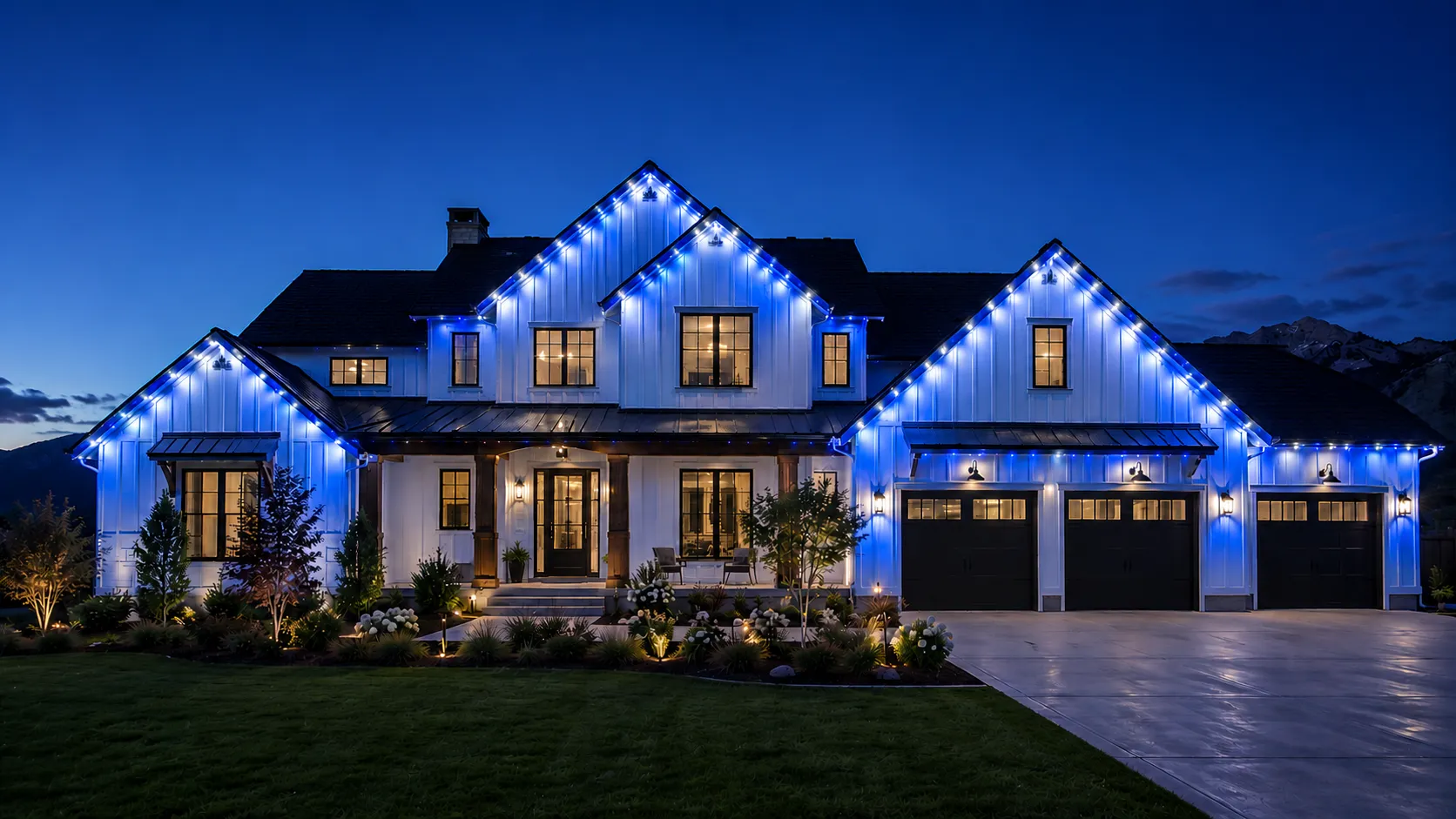 Same Cache Valley home with permanent roofline lighting set to USU Aggies blue and white for game day
